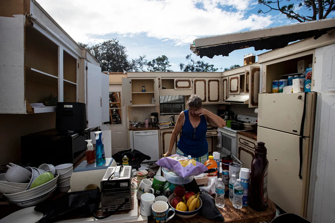 A resident in Florida is picking through the remains of her home, destroyed by the tornadoes. Photo: USA Today.