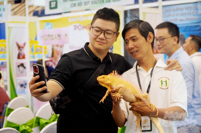 Many young people enjoy posing for photos with the South American dragon. Photo: Nguyen Thuy.