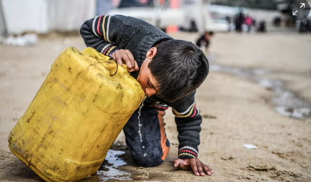 A child drinks from a plastic container in Gaza. More than 2 billion people lack access to safe drinking water. 