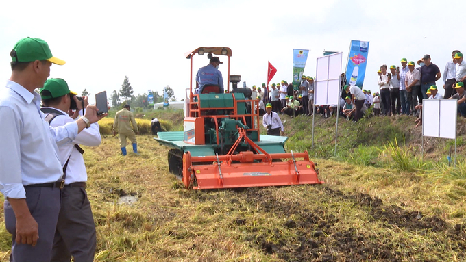 Farmers use machinery to manage straw after harvest.