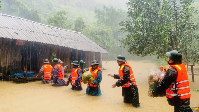 Bộ đội biên phòng Quảng Bình hỗ trợ di dời người dân vùng ngập đến nơi an toàn. Ảnh: T. Đức.