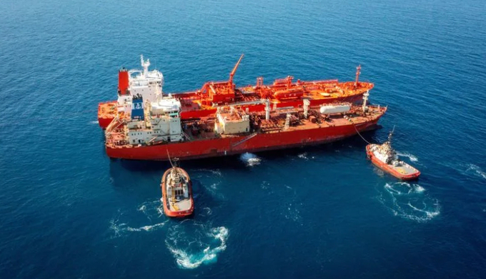 A view of the Green Pioneer and the Navigator Global with Rio Tinto tugboats at the anchorage of Port Dampier, Pilbara.