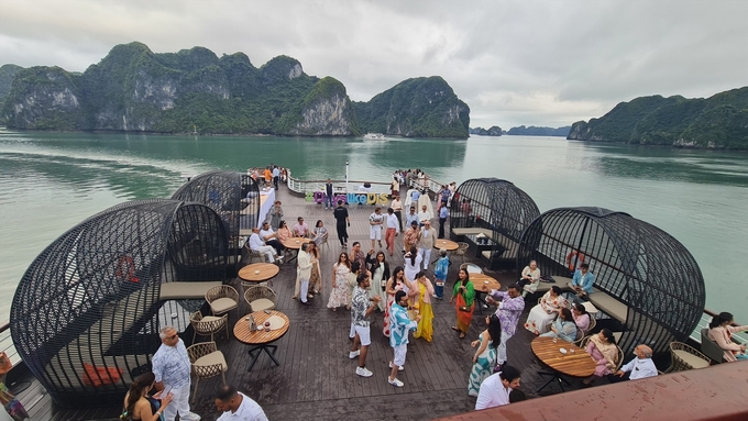 Foreign tourists explore Ha Long Bay.