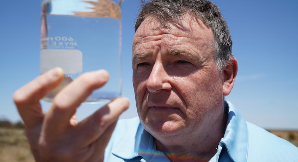 John Carragher examines saline groundwater extracted from a site in Waikerie. 