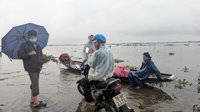 Người dân huyện Quảng Điền không thể di chuyển vì tuyến đường từ thành phố Huế về bị ngập sâu. Ảnh: Công Điền.