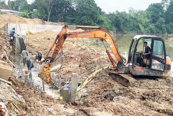 Nhà thầu đang phối hợp lực lượng công binh rà phá bom mìn thi công kè chống sạt lở hạ lưu cầu Chợ Vực. Ảnh: Thanh Nga.