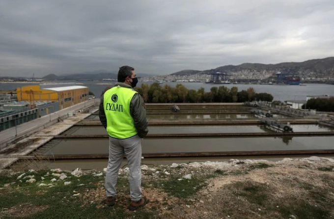 An employee gathers sewage samples at a wastewater treatment plant on the island of Psyttalia. 