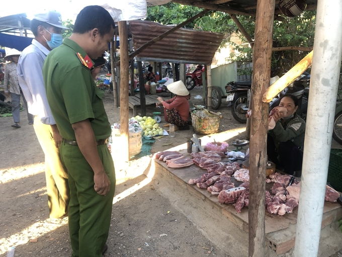 Lực lượng chức năng thị xã An Nhơn (Bình Định) kiểm tra thịt gia súc, gia cầm bán tại chợ. Ảnh: V.Đ.T.