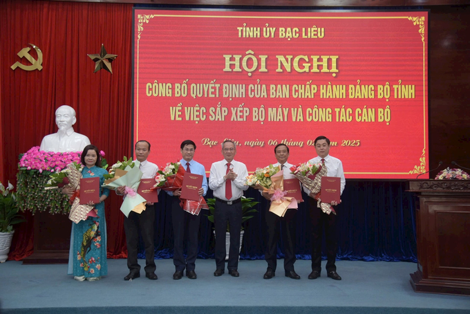 Bí thư Tỉnh ủy Bạc Liêu Lữ Văn Hùng trao quyết định, tặng hoa chúc mừng lãnh đạo Ban Tuyên giáo và Dân vận Tỉnh ủy. Ảnh: Trọng Linh.