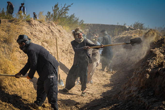 Construction workers dig trenches before gabions are built on the HariRud-Murghab river basin as part of community irrigation and livelihood enhancement - funded by Japan Government in Herat, Afghanistan.