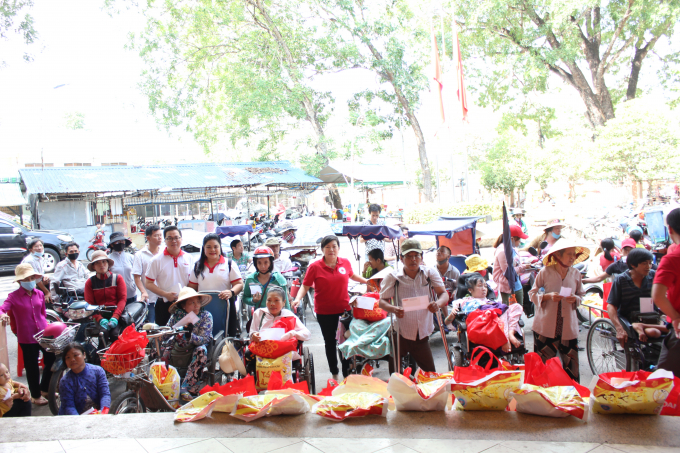 Đại diện Vedan và đại diện Hội Chữ thập đỏ huyện Long Thành trao quà cho người dân khuyết tật trên địa bàn. Ảnh: VĐ.