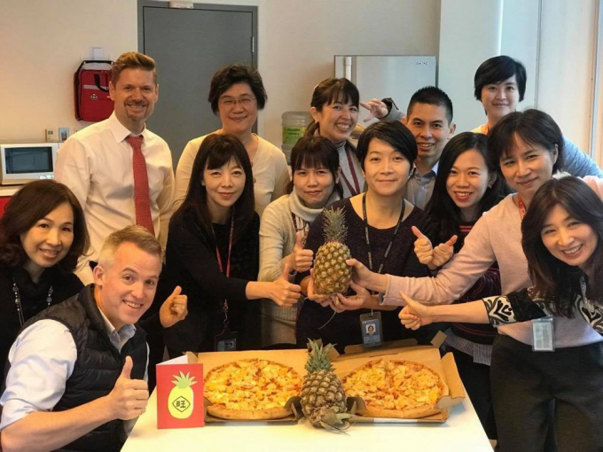 Ông Jordan Reeves cùng các nhân viên bên hai chiếc pizza và những trái dứa với thông điệp 'chúng tôi đặc biệt yêu thích dứa Đài Loan!'.