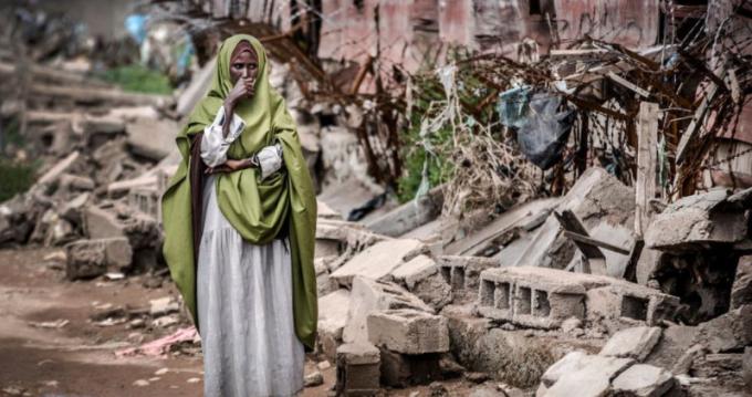 A woman in Somalia surveys the damage done by intense flooding. Photo: Getty