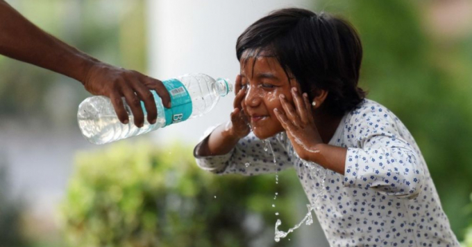A child cools down in India during a recent heatwave. Photo: Getty