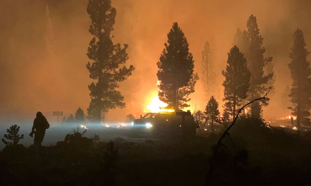 A firefighter and rig during night operations on Saturday night and Sunday morning at the Bootleg Fire, near Klamath Falls, Oregon. Photo: US Forest Service/AFP