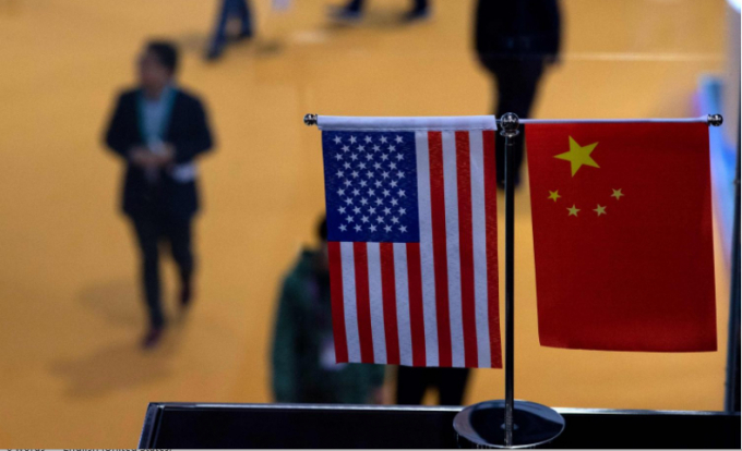Quốc kỳ Trung Quốc và Mỹ tại một gian hàng Hội chợ  Quốc tế ở Thượng Hải ngày 6/11/2018. Ảnh: AFP