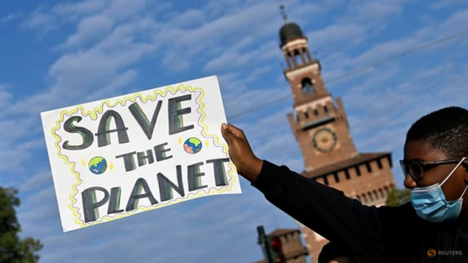 A demonstrator holds up a sign as he attends a Fridays for Future climate strike in Milan, Italy ahead of Glasgow's COP26 meeting. Photo: REUTERS/Flavio Lo Scalzo