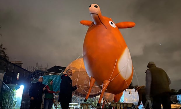 Activists parade with a giant inflatable cow to highlight the problem of methane emissions at a Cop26 march in Glasgow on Saturday. Photo: Climate Healers