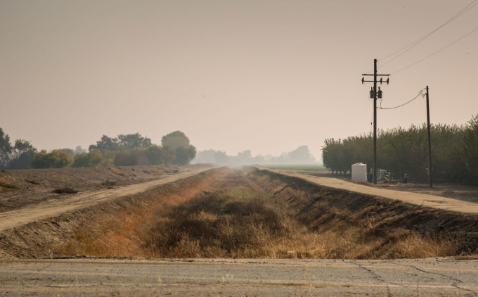 Pictured above: A dry agricultural irrigation canal along Highway 41 near Stratford, California.