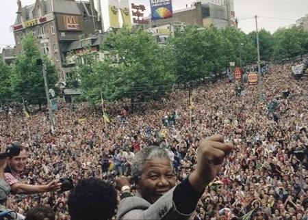 South African leader of the ANC Nelson Mandela raises his fist after addressing a crowd of about 15,000 people from the balcony of the city theater Saturday, June 16, 1990 in Amsterdam.