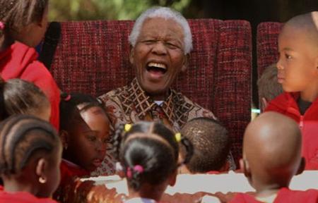 Nelson Mandela enjoying his 89th birthday celebrations at the Nelson Mandela Children's Fund in Johannesburg. Photograph: Denis Farrell/AP
