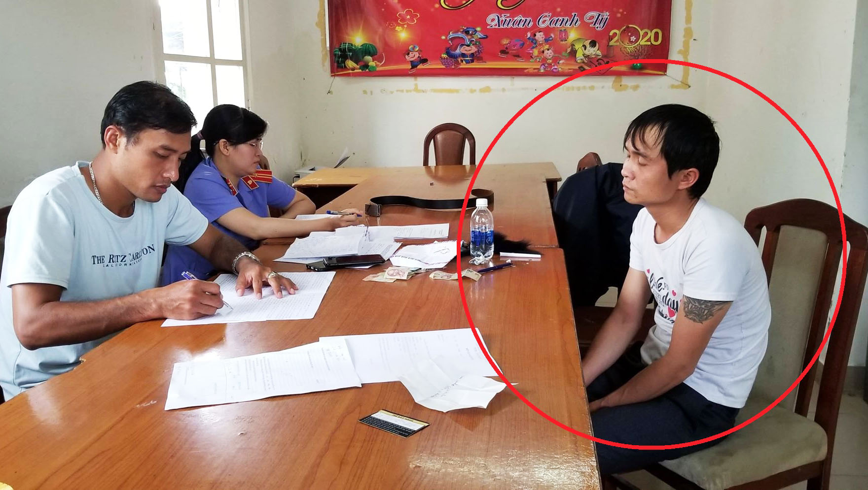 Nguyễn Văn Tuấn (vòng tròn đỏ) bị công an bắt giữ. Ảnh: L.V.