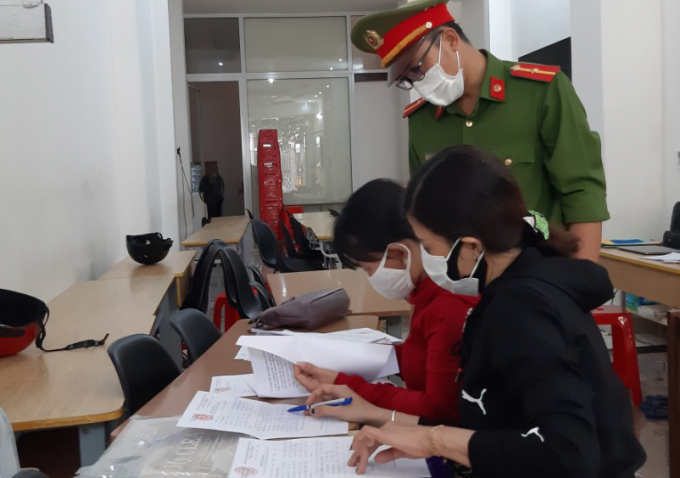 Lực lượng chức năng lập biên bản vi phạm đối với chủ cơ sở dạy thêm. Ảnh: Quang Yên.