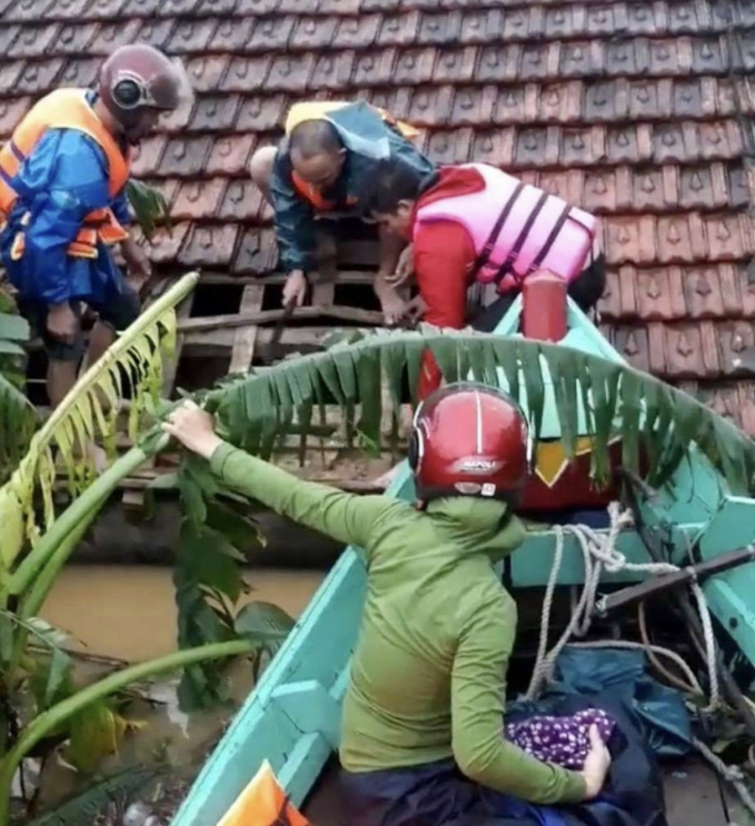 Ngư dân xã Hải Ninh cứu hộ người dân trong lũ dữ. Ảnh: T.Phùng