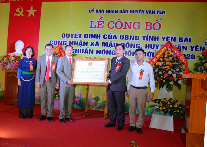 Ông Nguyễn Ngọc Xuân - Phó Giám đốc Sở NN-PTNT (thứ hai bên phải) trao bằng công nhận xã đạt chuẩn NTM cho lãnh đạo xã Mậu Đông. Ảnh: Thái Sinh.