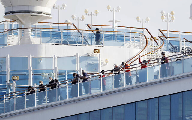 Hành khách đứng trên boong tàu du lịch Diamond Princess neo đậu tại cảng Yokohama ở Yokohama, gần Tokyo, ngày 12/2/2020. Ảnh: AP.