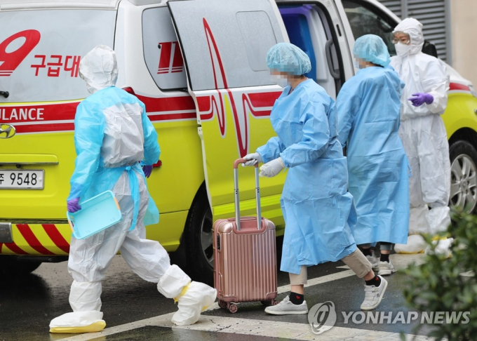Nhân viên y tế tại một bệnh viện ở phía tây nam thành phố Gwangju giúp bệnh nhân nhiễm virus Corona nhập viện. Ảnh: Yonhap.