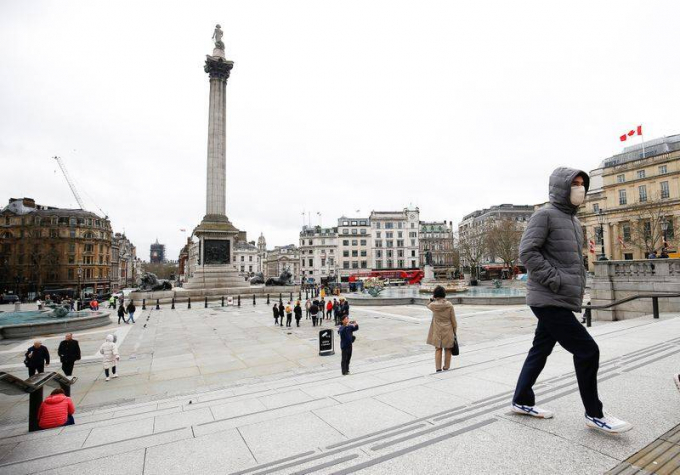 Một người đàn ông đeo khẩu trang bảo vệ đi qua Quảng trường Trafalgar, London, Anh, hôm 10/3/2020. Ảnh: Reuters.
