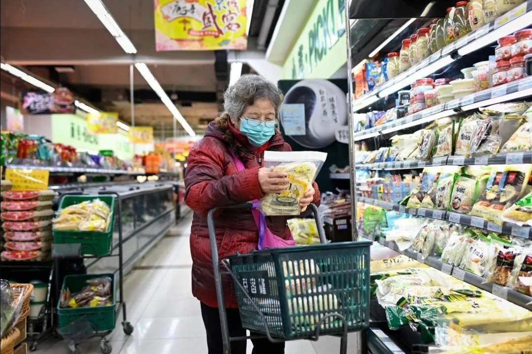 Người phụ nữ lớn tuổi mua sắm tại siêu thị ở Bắc Kinh, ngày 17/12/2020. Ảnh: AFP.