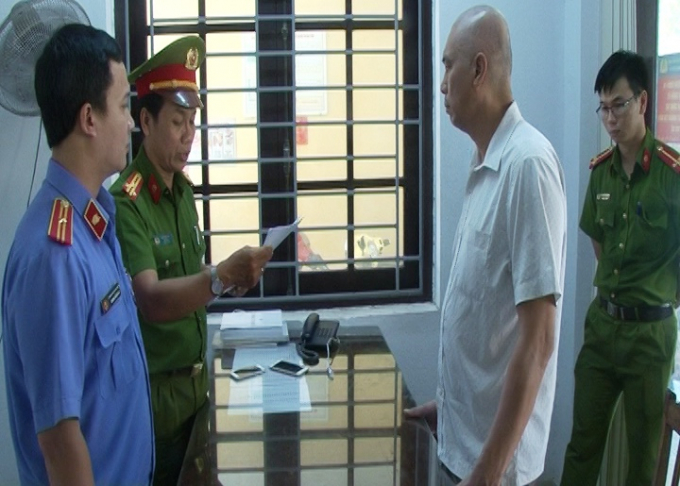 Lực lượng chức năng đang tiến hành lệnh bắt tạm giam đối  với Trần Quốc Đạt. Ảnh: Công an cung cấp.