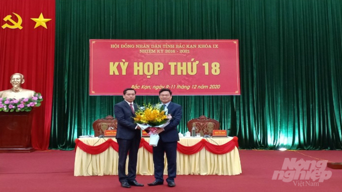Bí thư Tỉnh ủy Bắc Kạn Hoàng Duy Chinh (bên phải) tặng hoa chúc mừng ông Nguyễn Long Hải giữ chức vụ Chủ tịch UBND tỉnh Bắc Kạn. Ảnh: Toán Nguyễn.