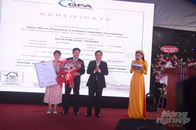 Ông Trần Nguyên Tú, Chủ tịch Công ty TNHH Lâm nghiệp Quy Nhơn (đứng giữa), nhận chứng chỉ FSC do bà Nguyễn Thị Tú Anh, đại diện Tổ chức GFA trao. Ảnh: Vũ Đình Thung.