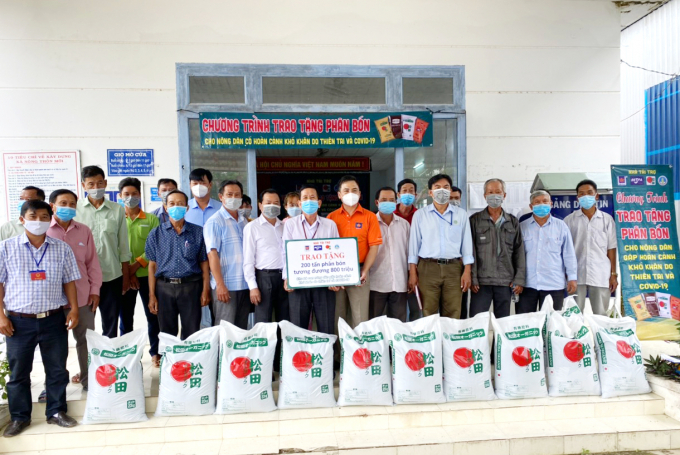 Ông Trần Văn Thắng, Giám đốc Công ty Cổ phần GFA (áo cam) trao tặng 200 tấn phân bón hữu cơ cho tỉnh Hậu Giang. Ảnh: Lê Hoàng Vũ.