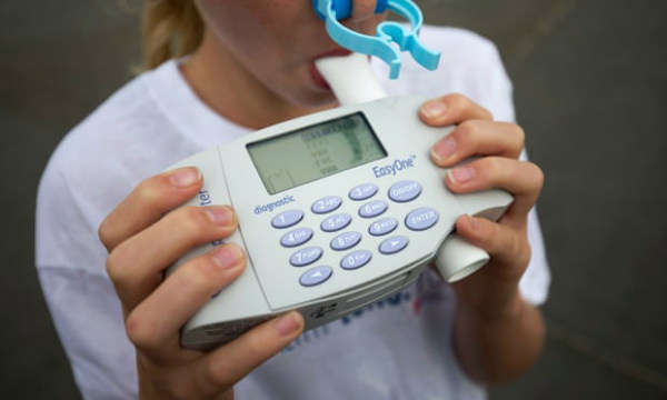 Một cô gái trẻ thổi vào phế dung kế trong một cuộc họp chụp ảnh (đăng báo) để thúc đẩy không khí sạch ở London. Ảnh: Justin Tallis / AFP / Getty Images