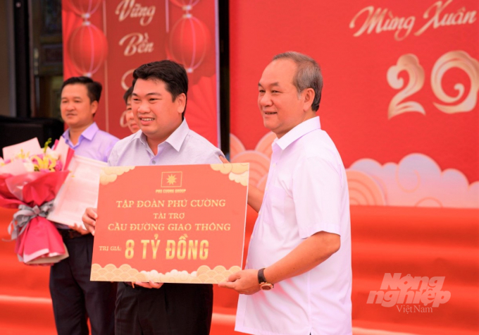 Ông Nguyễn Việt Cường (bên phải), Chủ tịch HĐQT Tập đoàn Phú Cường trao bảng tượng trưng tài trợ 8 tỷ đồng xây dựng cầu, đường giao thông nông thôn cho lãnh đạo huyện Vĩnh Thuận. Ảnh: Trung Chánh.
