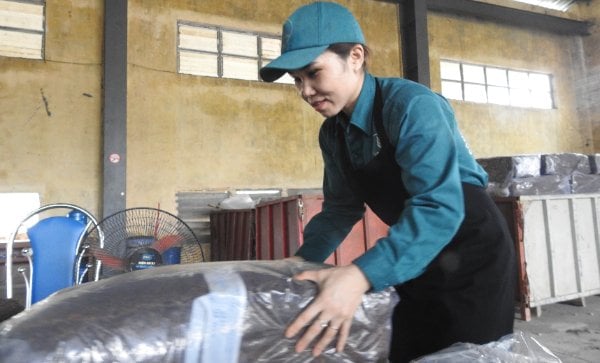 A factory worker packaging latex products.