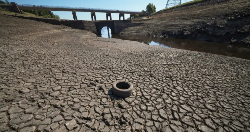 An ancient packhorse bridge is revealed at Baitings reservoir in the West Yorkshire Pennines, 2022. Photo: Christopher Furlong