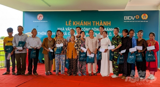 bidv-khanh-thanh-nha-cong-dong-tranh-lu-thu-10-cho-cac-tinh-mien-trung-152623_514-152623.jpg Đại diện lãnh đạo BIDV và chính quyền địa phương trao quà cho các hộ gia đình có hoàn cảnh khó khăn trên địa bàn xã Cam Hiếu. Ảnh: Công Điền.
