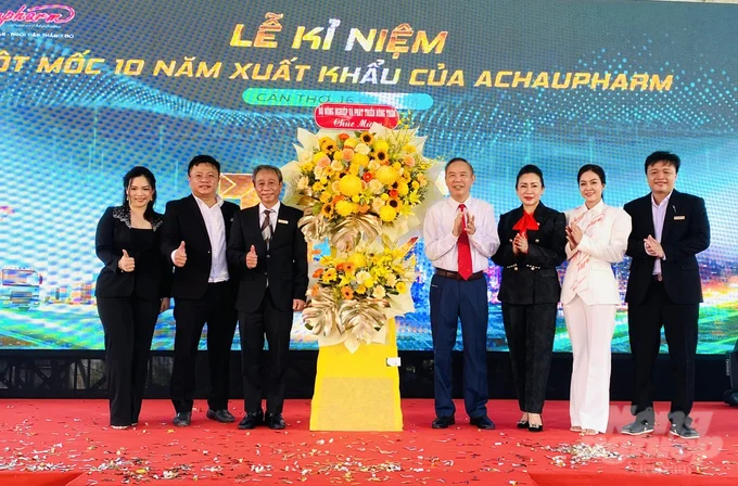 Deputy Minister of Agriculture and Rural Development Phung Duc Tien presents flowers to congratulate the leadership of Achaupharm on exporting their 500th order to the Middle Eastern market. Photo: Le Hoang Vu.