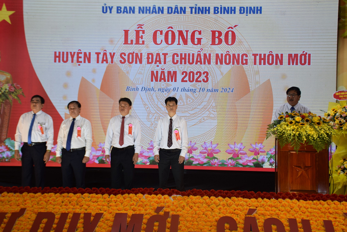 Ông Trần Văn Phúc, Giám đốc Sở NN-PTNT Bình Định đọc Quyết định công nhận huyện Tây Sơn đạt chuẩn nông thôn mới của Thủ tướng Chính phủ. Ảnh: V.Đ.T.