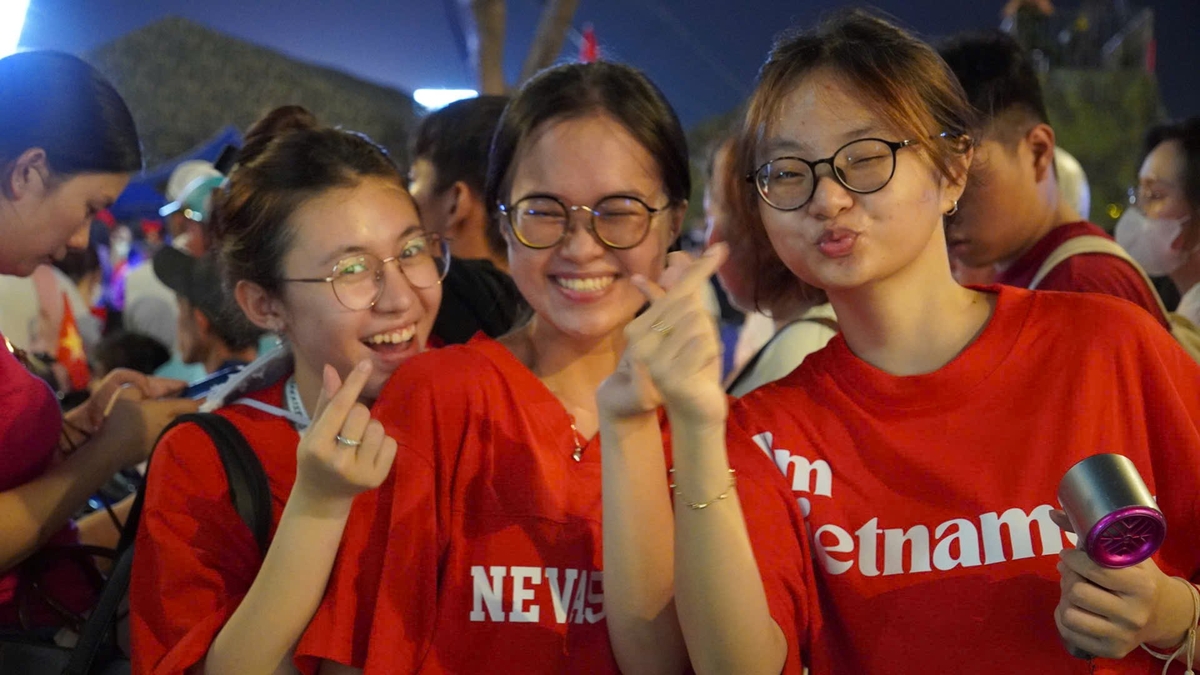 Ba cô gái trẻ mặc áo đỏ sao vàng tươi cười tạo dáng trong không khí sôi động của đêm 30/4, cùng hàng ngàn người dân xuống đường mừng đại lễ tại TP.HCM. Ba cô gái trẻ mặc áo đỏ sao vàng tươi cười tạo dáng trong không khí sôi động của đêm 30/4, cùng hàng ngàn người dân xuống đường mừng đại lễ tại TP.HCM.