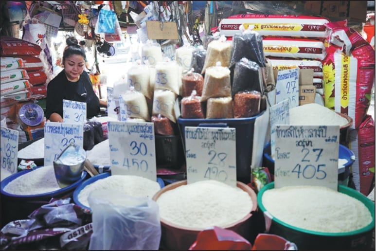 A rice vendor waits for customers at a market in Bangkok, Thailand, on April 7. Photo: RUNGROJ YONGRIT/EPA-EFE.