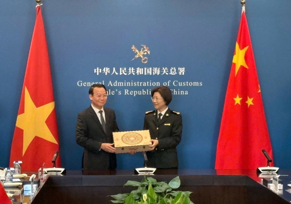 Minister Do Duc Duy presented a souvenir to Ms. Sun Mai Jun, Director General of the General Administration of Customs of China. Photo: ICD.