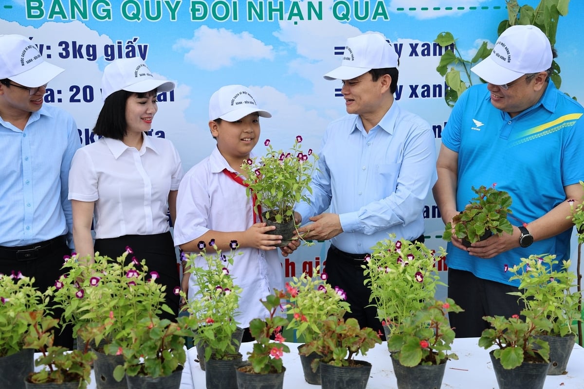Các đại biểu cùng tham gia chương trình Đổi rác thải nhựa lấy cây xanh. Ảnh: Nguyễn Nga.