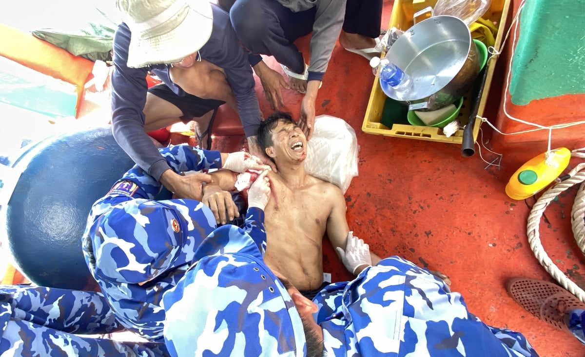 Cán bộ, chiến sĩ tàu Cảnh sát biển 8021 tiến hành sơ cứu, băng bó viết thương cho ngư dân. Ảnh: Đức Định. Cán bộ, chiến sĩ tàu Cảnh sát biển 8021 tiến hành sơ cứu, băng bó viết thương cho ngư dân. Ảnh: Đức Định.