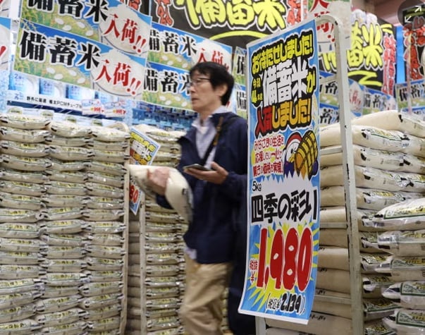 A customer walks past sacks of rice, released by the government from its reserve under a discretionary contract, at a branch of Japanese discount retailer Don Quijote. Photograph: JIJI PRESS/AFP/Getty Images.
